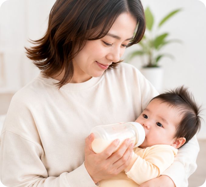 赤ちゃんにミルクをあげる母親